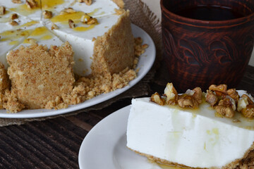 sliced walnut cheesecake and a clay cup with coffee
