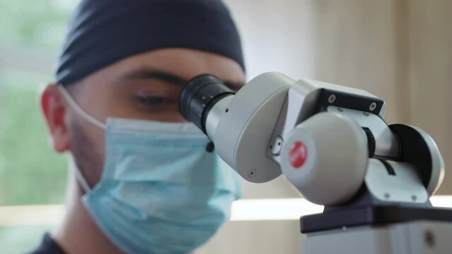 Man dentists with medical mask use special dental equipment that treats teeth. Hydience and healthy