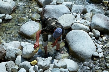 A man cleans the river bed from stones