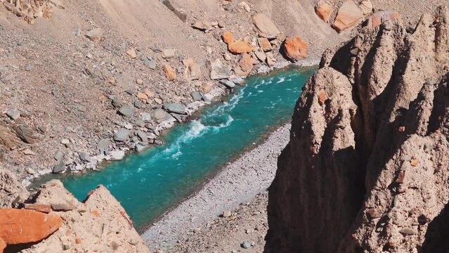 Blue Tsarap chu river flowing in the mountain valley of Zanskar as seen during the trek to Phugtal Monastery from Purne in Zanskar Valley, Ladakh, India. Beautiful blue river flowing in the Himalayas.