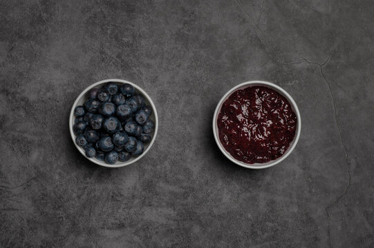 Blueberries and marmalade in white bowls