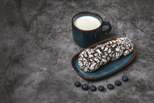 Chocolate crinkle cookies with blueberries and glas of milk 