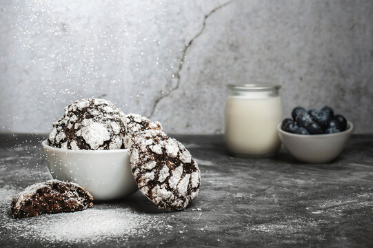 Chocolate crinkle cookies with blueberries and glas of milk