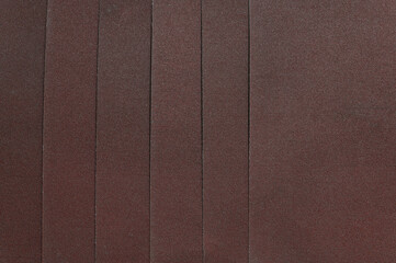 The background is made of sandpaper sheets. View from above.