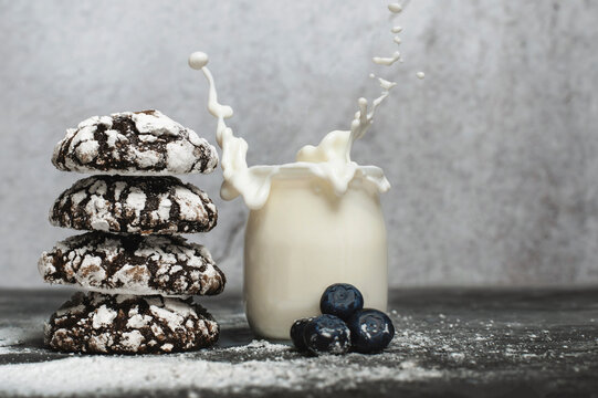 Chocolate crinkle cookies with blueberries and glas of milk