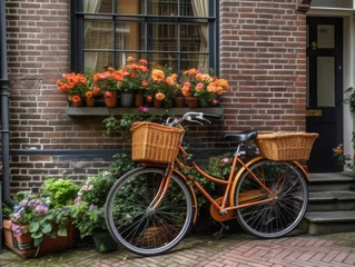 Fototapete Fahrrad A vintage bicycle with a wicker basket full of fresh produce stands parked in front of a red brick building.