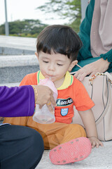 One year old Malay boy wears orange shirt