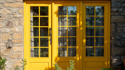 Fototapeta na wymiar Yellow entrance door to the stone house in Gokceada Imbros island. 