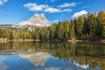 Mountain peak with reflections in a lake at autumn
