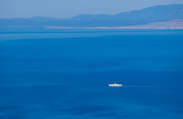 Aerial view to large cruise ship floating on sea with mountain. Travel, transportation background, Croatia