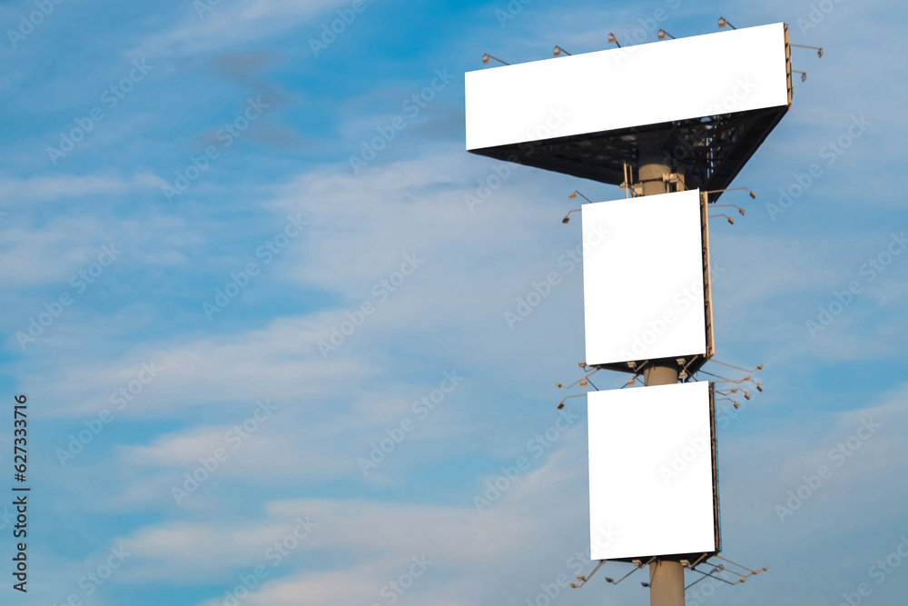 Canvas Prints mock up image: three blank white billboards or large displays on tower against blue sky with clouds.