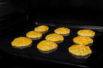 Process of cooking nine homemade crunchy oatmeal cookies on metal sheet in oven. Dessert, cookery, baking, gastronomy and food concept