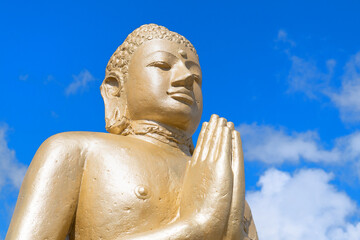 Golden Buddha against blue sky