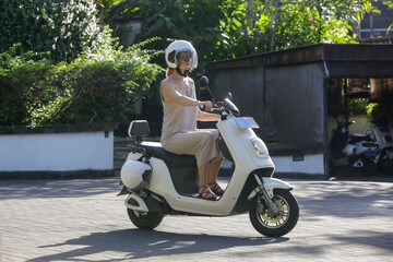 Woman tourist riding an electric scooter