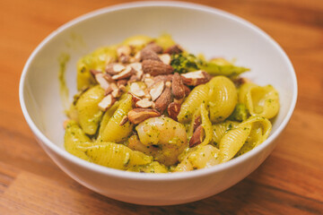 Prawn pesto pasta bowl on wooden table