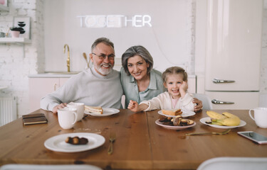 Happy family having breakfast together