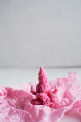 The candle with the goddess Lakshmi is pink. Femininity and fertility. Meditation and Buddhism
