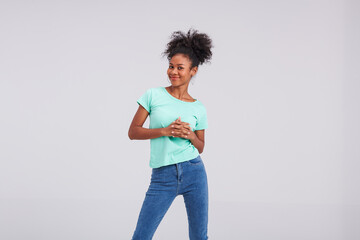 With minty fresh appeal, a Thai American woman showcases her style in a mint shirt and blue jeans during the studio session.