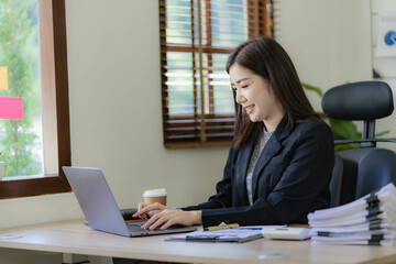 Business woman using tablet and laptop to do financial math, tax, reporting, accounting, statistics and analytical research concept. Make documents at work using your computer's online software.