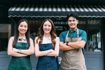 Group of Asian Man and Women Crossing Arms in Trendy Cafe Restaurant. Confident Business People or Shop Owners Standing Arms Crossed At Front of Super Market Shop. Small Business Owner Concept