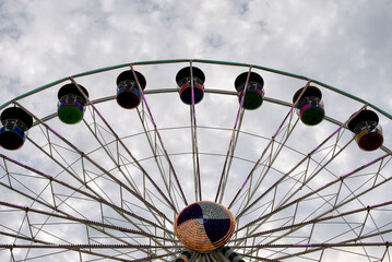 Part of ferris wheel against clouds sky background