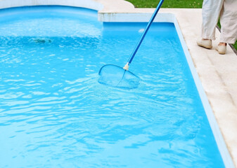 Fototapeta na wymiar Cleaning the pool on summer holidays