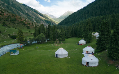 Traditional nomad's yurt by river. Nomad's life. Beautiful mountain landscape with the white Yurts....