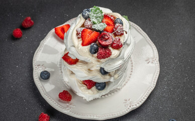 Meringue dessert Pavlova with fresh berries, cookbook recipe top view