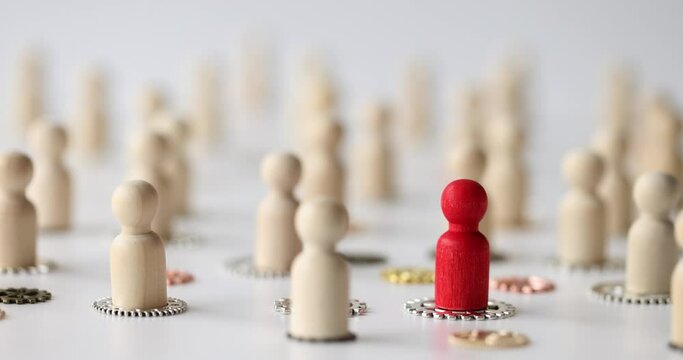 Person puts red figurine with metal gears in closeup. Recruitment and team building
