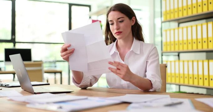 Worried frustrated woman shocked bad news or refusal to read letter in office. Stressed manager worried about financial problems