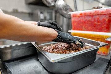 Chef cooking food at restaurant kitchen close up