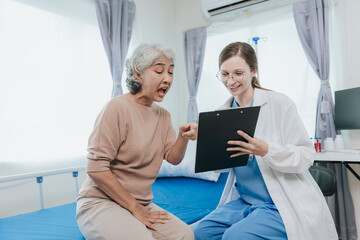 Obraz premium Young beautiful smiling doctor nurse caring to help happy senior grandmother helping old patients in rehabilitation at elderly health checkup