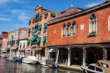 Fototapeta na wymiar Murano Houses & Shops along with the channels Venice, Italy. Murano is famous by glass production factories