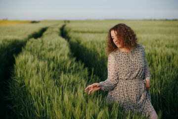 Curly girl standing on the field