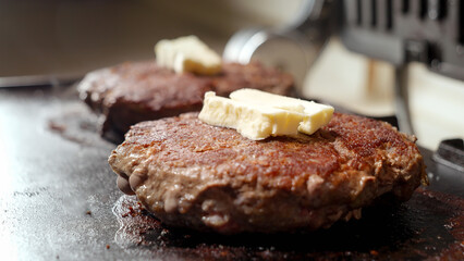 Cooking beef patties for burgers on electric grill. Cooking at home, kitchen appliance, healthy nutrition, hamburger ingredients.