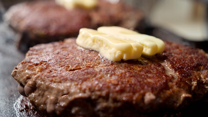 Closeup of butter melting on cooking beef burger patties on grill. Cooking at home, kitchen appliance, healthy nutrition, hamburger ingredients.