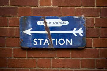 Weathered old railway station sign on brick wall © Lance Bellers