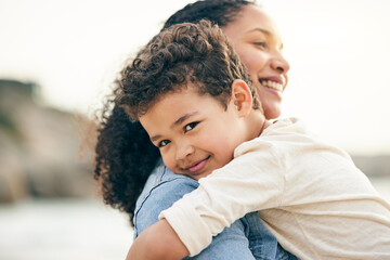 Hug, portrait and a mother and child at the beach for summer, holiday or happiness together. Smile, care and mom with a kid at the ocean for a vacation, bonding or travel in Costa Rica for love