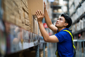 supply chain and logistic network technology concept. Happy Asian worker in blue uniform with...