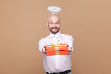 Portrait of friendly bald bearded man with nimb over head, congratulating with Valentines Day,...