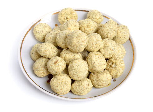 Kashk, qurut, gurt, chortan, or aaruul and khuruud. With herbs isolated on white background