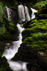 Into the wild, waterfalls in the Alps mountains
