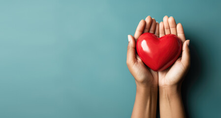 Hand giving red heart , charity symbol - obrazy, fototapety, plakaty