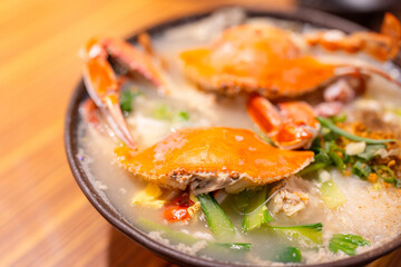 Seafood congee bowl with crab in restaurant
