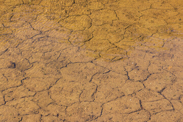 River though the dry soil cracked ground