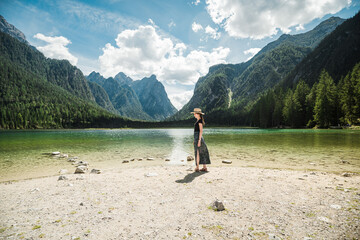 Beautiful female model at lago di dobbiaco in Italy, the dolomites - obrazy, fototapety, plakaty