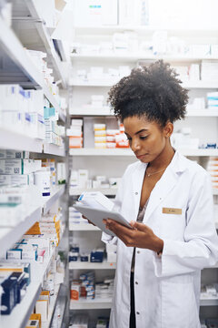 I have the right tools to keep my pharmacy under control. Cropped shot of a pharmacist using a digital tablet in a chemist.