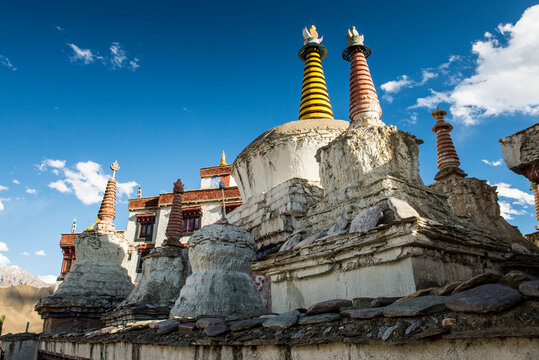 Close-up of stupas with mountain top building complex of a Tibetan Buddhist,  Monastery in Ladakh; Ladakh, Jammu and Kashmir, India