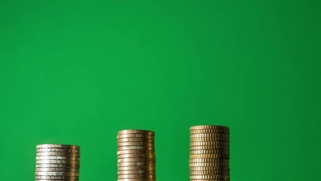 Coins in stop motion on green screen grow towards each other in a ladder