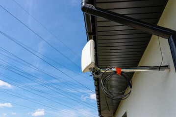 Antenna amplifier for mobile internet at home, mounted on the facade of the house outside.